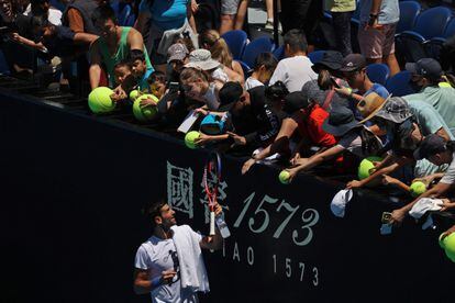 Djokovic firma autógrafos a los aficionados en la central de Melbourne.