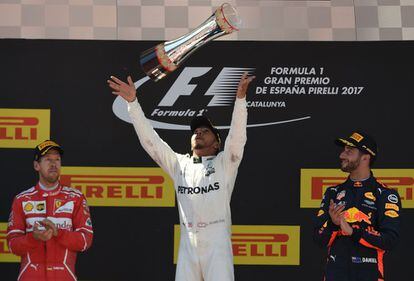 Lewis Hamilton (centro) lanza su trofeo acompañado de Sebastian Vettel (izquierda) y Daniel Ricciardo.
