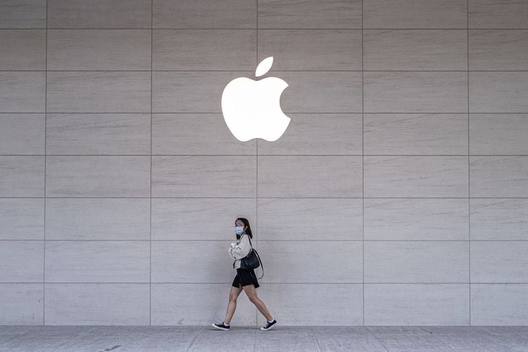 A woman walks past an Apple store in Taipei, Taiwan, on November 15.