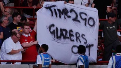 Un aficionado del Manchester United sostiene una pancarta contra la familia Glazer.