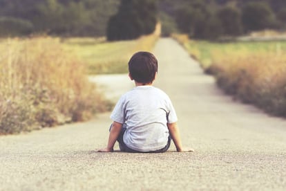 Un niño mira el horizonte.