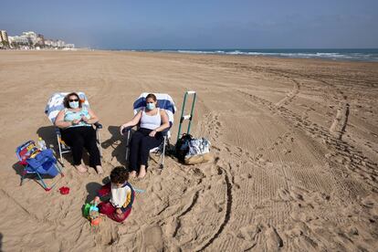 Desde este miércoles entra en vigor la normativa de llevar mascarilla en cualquier espacio público, incluso aquellos en los que se garantice la separación entre personas de más de 1,5 metros. En la image, varias personas toman el sol en la playa de Gandía (Valencia).