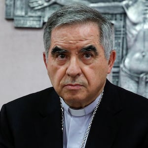 Cardinal Giovanni Angelo Becciu, who has been caught up in a real estate scandal, meets with the media a day after he resigned suddenly and gave up his right to take part in an eventual conclave to elect a pope, near the Vatican, in Rome, Italy, September 25, 2020. REUTERS/Guglielmo Mangiapane