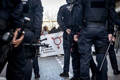 Mossos d'Esquadra cortan el paso de las manifestantes anticapitalistas a la zona comercial de Girona, durante los actos reivindicativos celebrados esta mañana con ocasión del Día Internacional de la Mujer.