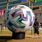 SEVILLA, 12/06/2021,- Aficionados se fotografían junto a una réplica del balón del torneo en el estadio de La Cartuja de Sevilla. El España-Suecia, con el que la selección que entrena Luis Enrique inicia la Eurocopa el próximo lunes, será el tercero con aficionados en el estadio sevillano desde que en marzo del pasado año se dictaron normas sanitarias por la covid-19 y solo puntualmente se autorizó la presencia de espectadores en los recintos deportivos. EFE/Julio Muñoz