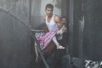 Un hombre lleva a una niña en brazos, herida durante un bombardeo israelí, en Jan Yunis, al sur de Gaza.