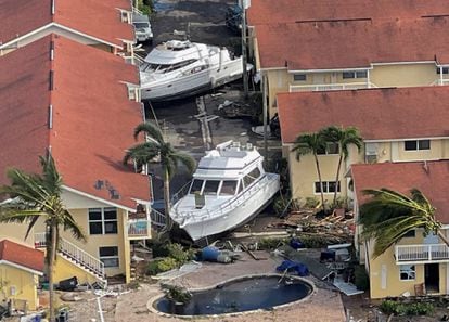 Boats stranded between buildings that were damaged by the hurricane.