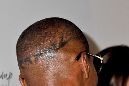 Jamie Foxx shows off the tattoo that decorates her head at an awards ceremony at the Beverly Hilton hotel in 2013 in Los Angeles.