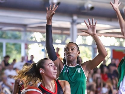 Kendall Martin, con la camiseta verde, trata de impedir la canasta de una jugadora rival.