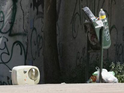 Papeleras rebosantes y desperdicios en el suelo de una calle de Madrid el pasado s&aacute;bado. 