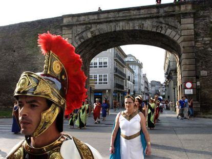 Un centuri&oacute;n durante la celebraci&oacute;n de Arde Lucus, con la muralla romana, patrimonio mundial, de fondo.