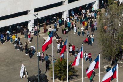 Gente formada a las afueras del colegio electoral instalado en el Estadio Nacional, en Santiago.