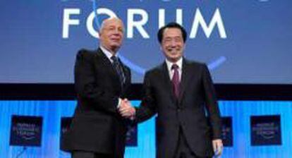 El primer ministro japonés Naoto Kan estrecha la mano del fundador del Forod de Davos, Klaus Schwab.