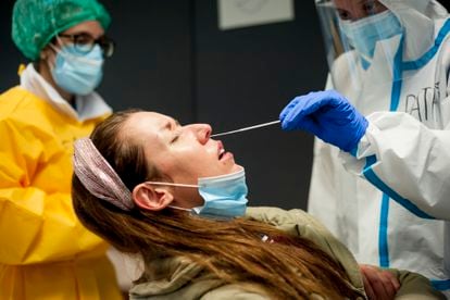 Un sanitario realiza un test de antígenos a una mujer en el distrito Ciutat Vella de Barcelona.
