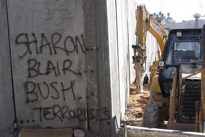Una pintada en la que puede leerse "Sharon, Blair y Bush, terroristas", en el muro israelí.