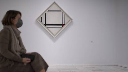 Una mujer sentada frente a una obra de Mondrian.