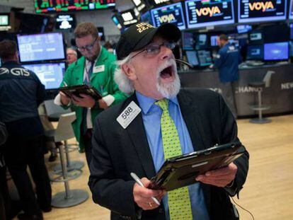 Un 'broker', con una gorra que celebra el récord de 22.000 puntos del Dow Jones, al cierre de la jornada en la Bolsa de Nueva York el 2 de agosto.