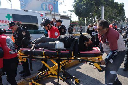 Miembros de los servicios de emergencia trasladan a una mujer herida, tras un choque por alcance de vagones en un túnel de la Línea 3 del metro.