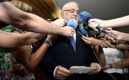 El presidente de las Cortes Valencianas, Juan Cotino, mira un papel con notas durante sus declaraciones a los medios.