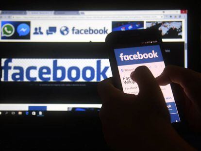 (FILES) In this file photo taken on March 22, 2018 a cellphone and a computer screen display the logo of the social networking site Facebook in Asuncion.  A US consumer protection agency said March 26, 2018 it has opened an investigation into Facebook for potentially failing to live up to its promises on privacy and possible violations of a consent decree.The Federal Trade Commission confirmed news reports from last week that it had opened an inquiry over the harvesting of Facebook data on tens of millions users of the social network by the British consulting group Cambridge Analytica.  / AFP PHOTO / NORBERTO DUARTE