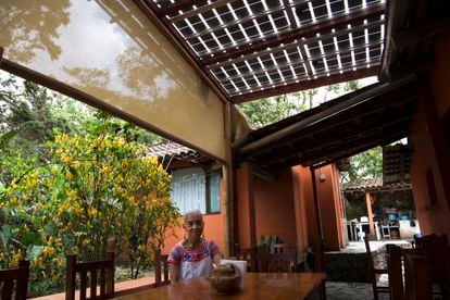 Rufina Vila, president of a workers' cooperative, poses under the solar roof installed in the eco-hotel she manages in Cuetzalan, Mexico.