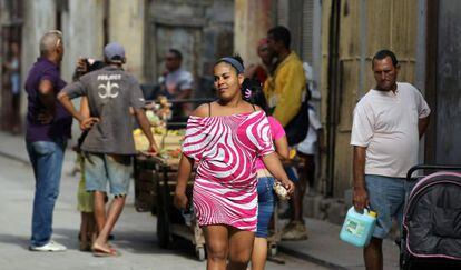 Una mujer camina por una calle de La Habana.