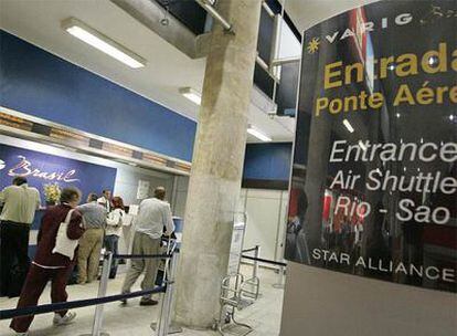 Varios pasajeros recogen sus tarjetas de embarque en el aeropuerto Santos Dumont de Río de Janeiro.