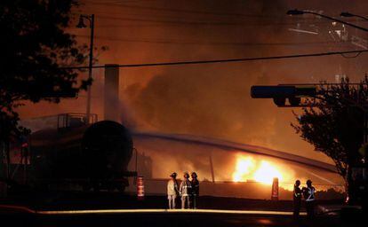 Los bomberos apagan los vagones del tren siniestrado en la ciudad de Lac Megantic, Quebec,