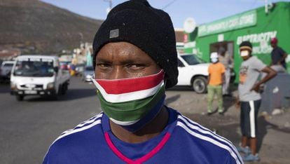 Un hombre sudafricano lleva una mascarilla casera con los colores de su bandera.