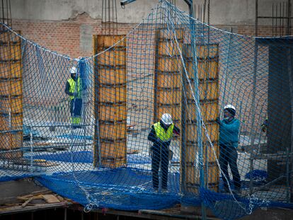 Tres personas trabajan en la construcción de un edificio en Madrid, el 4 de enero.