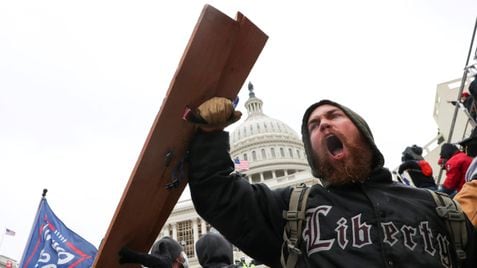 A man shouts as supporters of U.S. President Donald Trump gather in front of the U.S. Capitol Building in Washington, U.S., January 6, 2021. REUTERS/Leah Millis     TPX IMAGES OF THE DAY