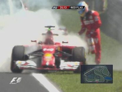 Fernando Alonso intenta apagar el fuego de su Ferrari.