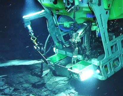 Robot submarino extrayendo muestras biológicas y de sedimentos del yacimiento.