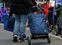 People queue with their shopping trolleys at a distribution point of the food bank "Essener Tafel", as the spread of the coronavirus disease (COVID-19) continues in Essen, Germany, March 30, 2020. REUTERS/Leon Kuegeler