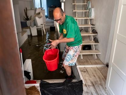 Un hombre retira agua de su vivienda en Valencia, este miércoles.