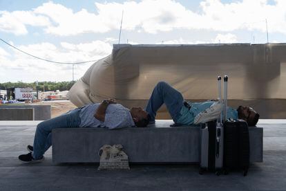 Passengers wait at the Cancun station of the Mayan Train, the train trip was delayed five hours 