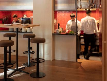 Mesas altas con taburetes junto a la cocina del Rabbit's de Barcelona, en una imagen proporcionada por el restaurante.