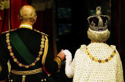 La reina Isabel II de Inglaterra acompañada por su esposo Felipe de Edimburgo, a su salida del Parlamento de Westminster, en Londres (Reino Unido), donde leyó su discurso de apertura de la legislatura en la Cámara de los Lores, el 26 de noviembre de 2003.