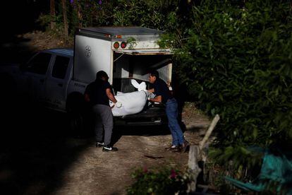 Dos agentes recogen el cuerpo de un asesinado en San Salvador. 