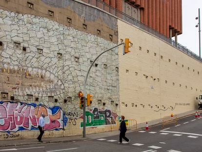 El tiburón del artista Blu, en el barrio del Carmel de Barcelona, tapado parcialmente por el Ayuntamiento para reparar el muro.