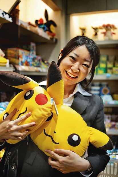 Una compradora sostiene dos peluches con la cara de Pikachu, el personaje más icónico de Pokémon.