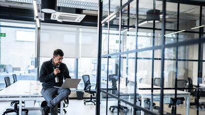 Mature man working using laptop in the office