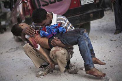 La imagen ganadora del premio Pulitzer: un hombre sirio llora sobre el cuerpo de su hijo cerca del hospital de Aleppo, en Siria (octubre, 2012).