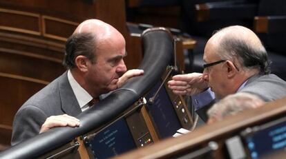 Luis de Guindos y Cristóbal Montoro cambian impresiones en una sesión de control al Gobierno en el Congreso