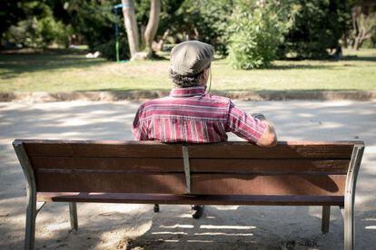 Un jubilado en un banco de un parque de Barcelona