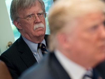 (FILES) In this file photo US President Donald Trump speaks alongside National Security Adviser John Bolton (L) during a Cabinet Meeting in the Cabinet Room of the White House in Washington, DC, May 9, 2018. - Donald Trump said on June 20, 2020 his former national security advisor John Bolton would pay a "big price" for what the president described as an illegal tell-all memoir. (Photo by SAUL LOEB / AFP)