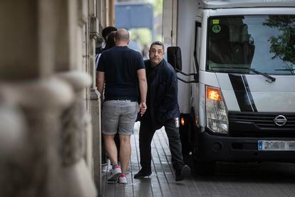 A delivery man parks his van on a sidewalk in the center of Barcelona. 