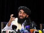 Taliban spokesman Zabihullah Mujahid speaks at his first news conference, in Kabul, Afghanistan, Tuesday, Aug. 17, 2021. For years, Mujahid had been a shadowy figure issuing statements on behalf of the militants. Mujahid vowed Tuesday that the Taliban would respect women's rights, forgive those who resisted them and ensure a secure Afghanistan as part of a publicity blitz aimed at convincing world powers and a fearful population that they have changed. (AP Photo/Rahmat Gul)