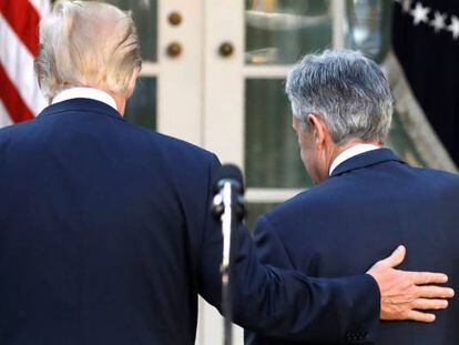 El presidente de EE UU, Donald Trump, apoya su mano sobre la espalda del presidente de la Fed, Jerome Powell.