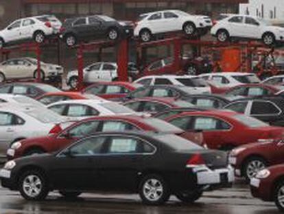 File of newly built cars sit in a shipping lot near General Motors Car assembly plant in Oshawa